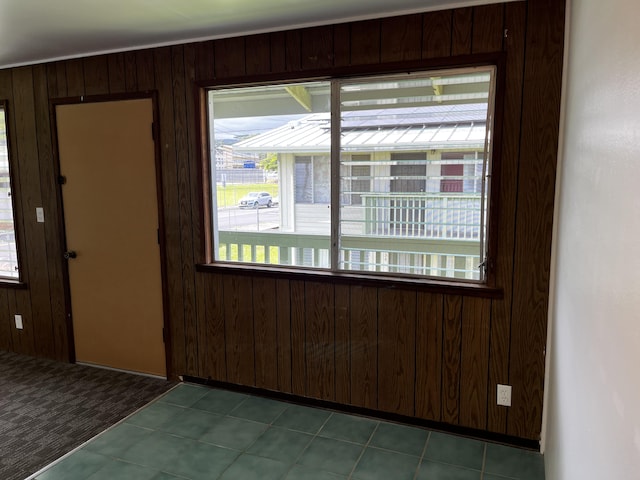 tiled empty room with wood walls