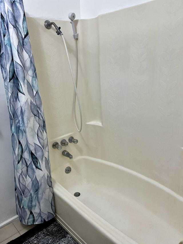 bathroom with tile patterned flooring and shower / bath combo with shower curtain