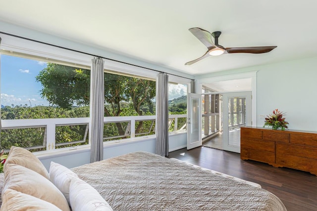 bedroom featuring wood finished floors, a ceiling fan, and access to exterior