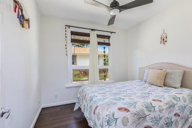 bedroom with a ceiling fan, dark wood-style flooring, and baseboards