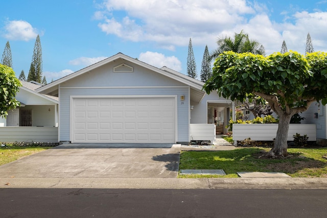 ranch-style house featuring a garage and concrete driveway