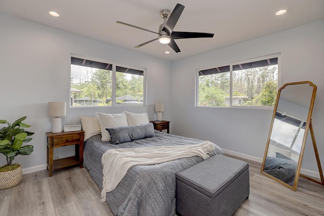 bedroom with baseboards, ceiling fan, light wood finished floors, and recessed lighting