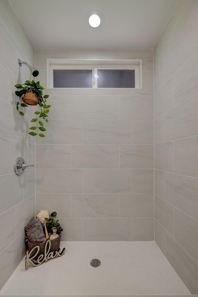 bathroom with a tile shower