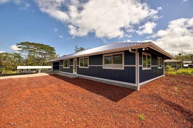 view of side of property featuring metal roof