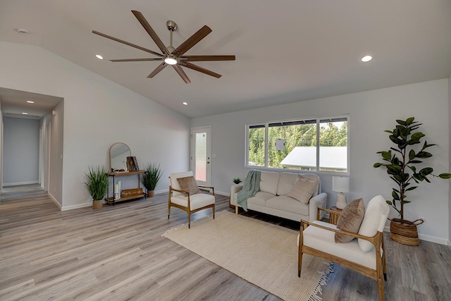 living area featuring lofted ceiling, recessed lighting, a ceiling fan, wood finished floors, and baseboards