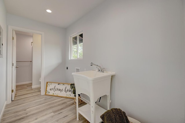 washroom with laundry area, light wood finished floors, hookup for a washing machine, electric dryer hookup, and recessed lighting