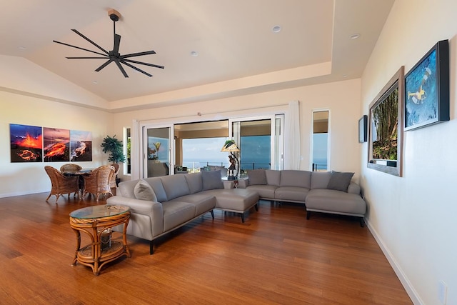 living room with a healthy amount of sunlight, baseboards, lofted ceiling, and wood finished floors