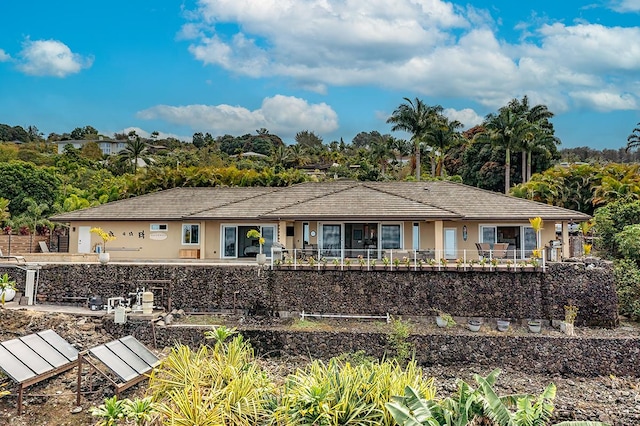 back of property featuring stucco siding