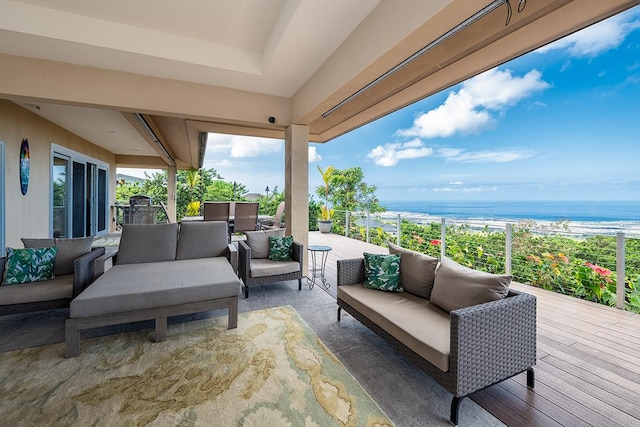 view of patio with a deck with water view and outdoor lounge area