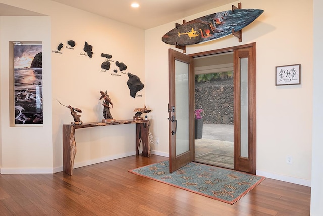 entryway with wood finished floors and baseboards