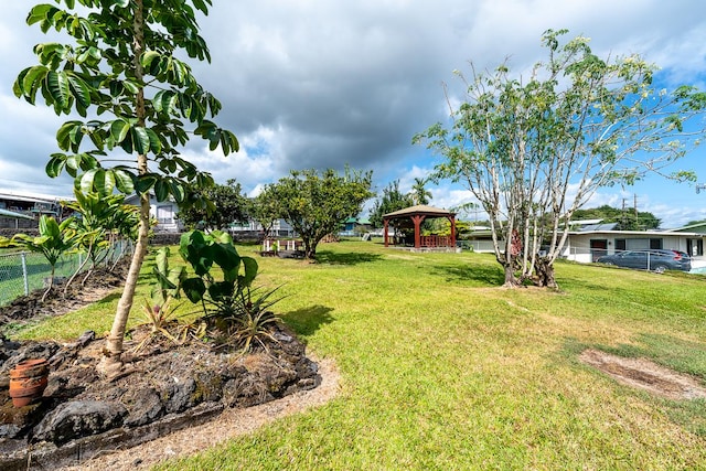 view of yard featuring fence and a gazebo