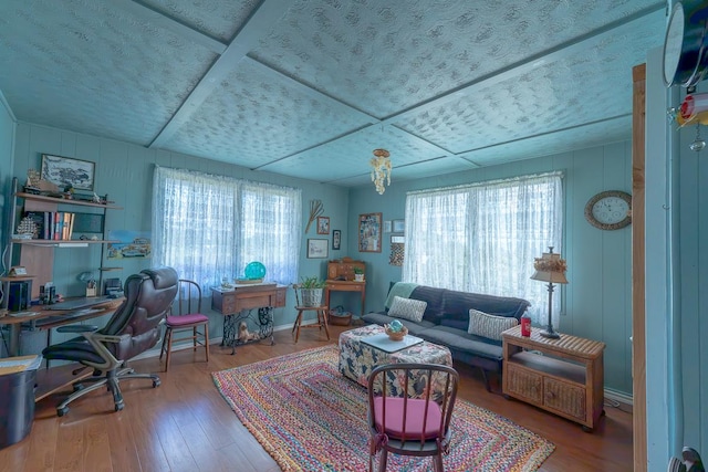 office space featuring plenty of natural light, wood finished floors, and baseboards