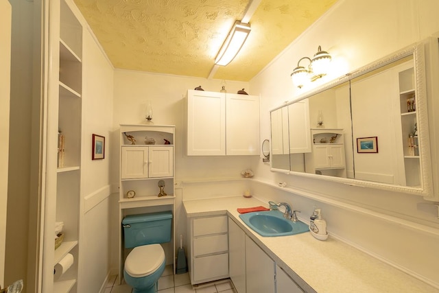 bathroom featuring a textured ceiling, toilet, tile patterned flooring, and vanity