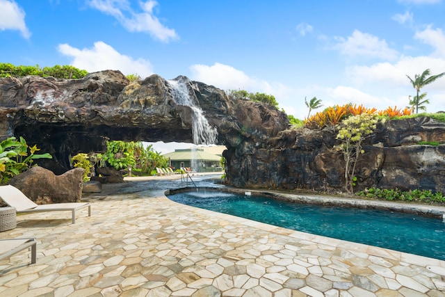 outdoor pool with a patio area and a mountain view