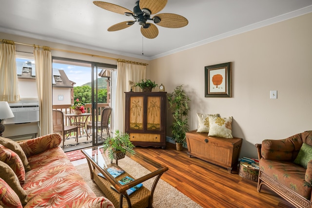 living area featuring ceiling fan, cooling unit, wood finished floors, and ornamental molding