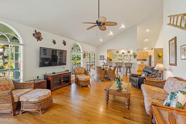 living area featuring ceiling fan, high vaulted ceiling, light wood finished floors, and recessed lighting