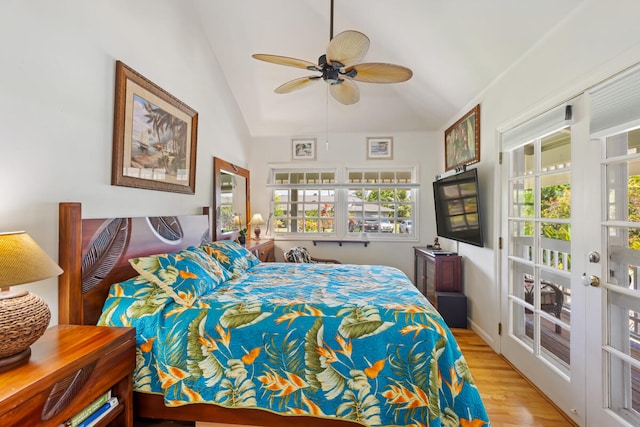 bedroom featuring ceiling fan, light wood-style flooring, and vaulted ceiling