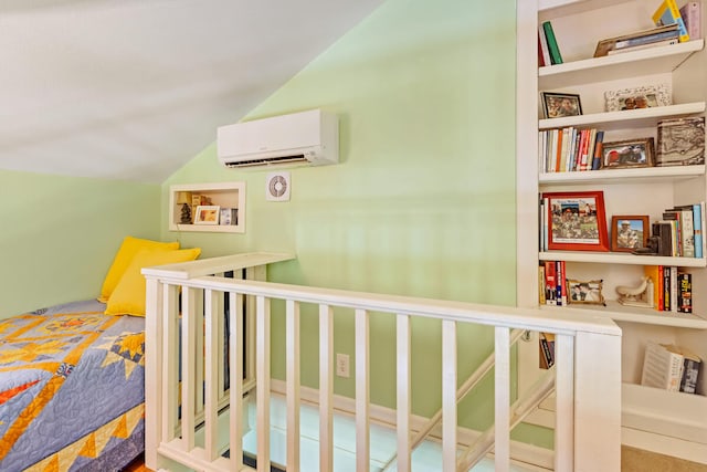 bedroom featuring lofted ceiling and a wall mounted air conditioner