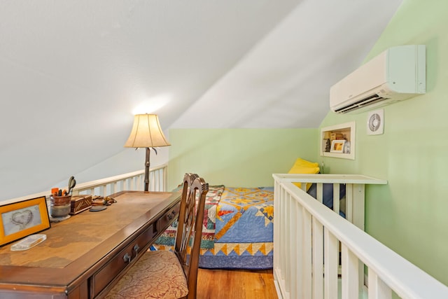 bedroom featuring lofted ceiling, a wall mounted air conditioner, and wood finished floors