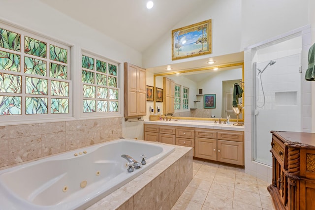 bathroom with double vanity, vaulted ceiling, a shower stall, tile patterned flooring, and a whirlpool tub