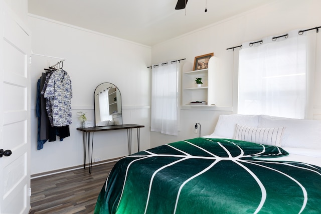 bedroom featuring a ceiling fan, crown molding, and wood finished floors