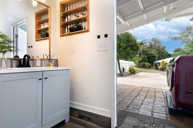 bar with a sink and baseboards