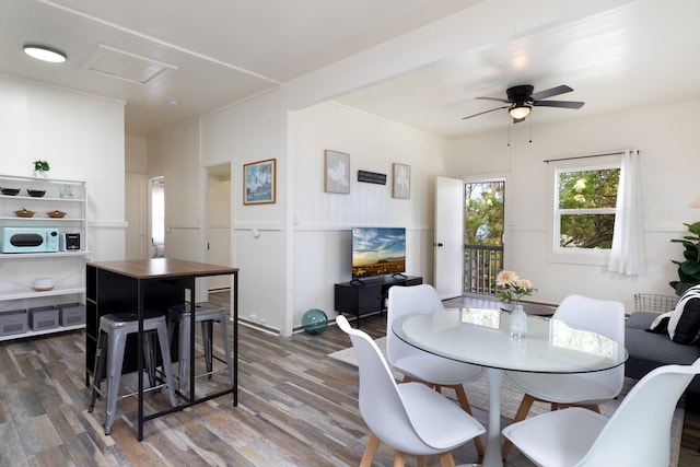 dining room with a ceiling fan and wood finished floors