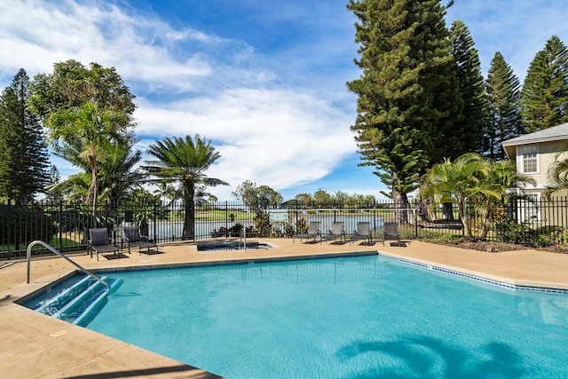 pool featuring fence and a patio