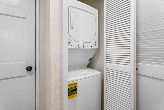 laundry area with stacked washer and dryer and laundry area