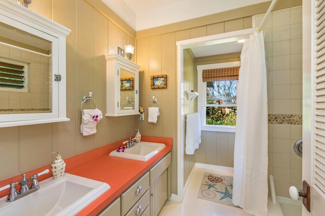 bathroom featuring a sink and double vanity