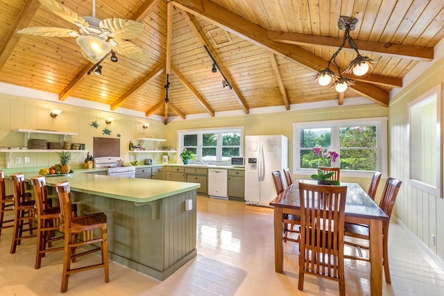 kitchen with lofted ceiling with beams, wood ceiling, ceiling fan, white appliances, and a peninsula