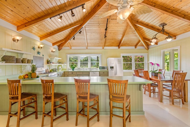 kitchen with lofted ceiling with beams, light countertops, white appliances, and wooden ceiling