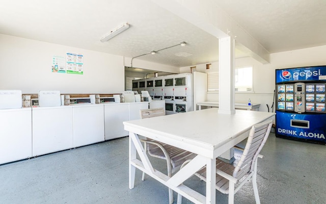 dining space featuring speckled floor and independent washer and dryer