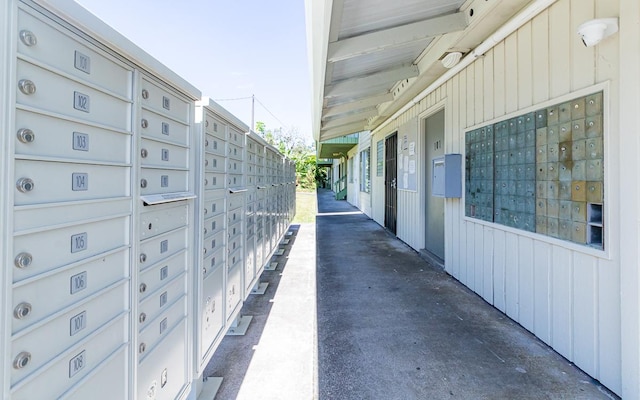 exterior space featuring a garage and mail area