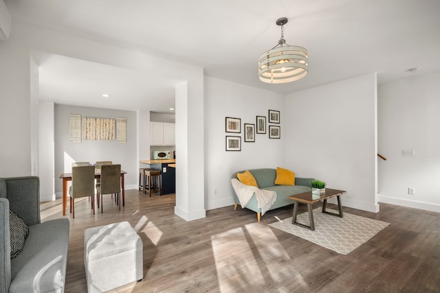 sitting room featuring recessed lighting, baseboards, an inviting chandelier, and wood finished floors