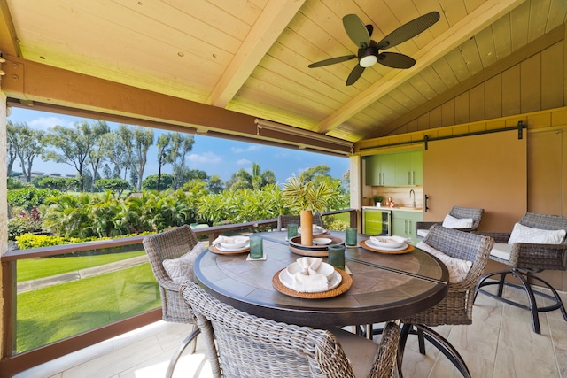 exterior space featuring ceiling fan, beverage cooler, outdoor dining area, and a sink