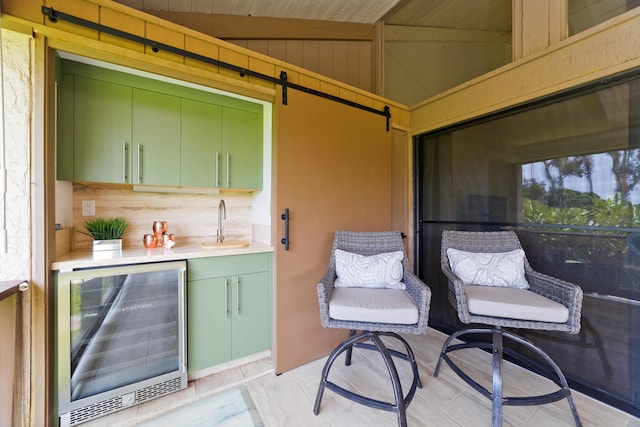 view of patio with beverage cooler and a sink