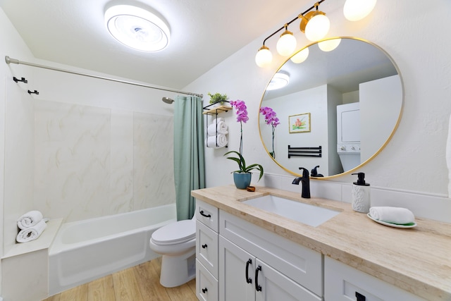 bathroom featuring vanity, shower / bathtub combination with curtain, toilet, and wood finished floors