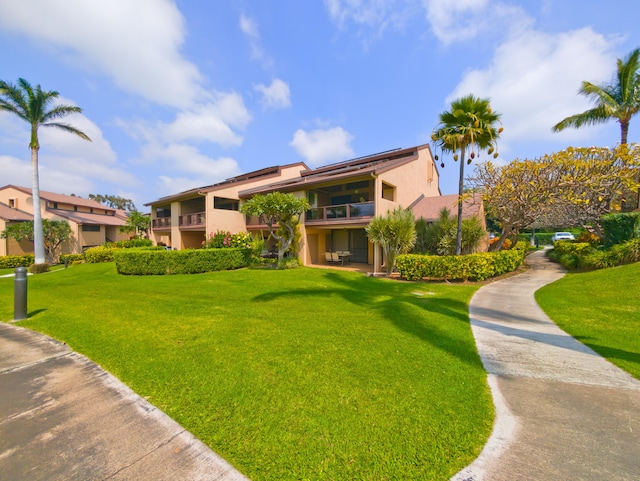 view of home's community featuring a lawn