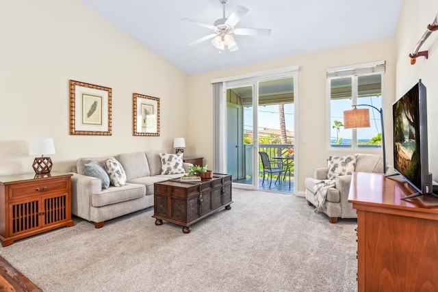 carpeted living room featuring lofted ceiling, baseboards, and ceiling fan