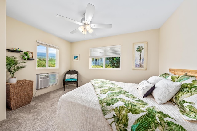 bedroom with carpet flooring, a wall mounted air conditioner, and a ceiling fan