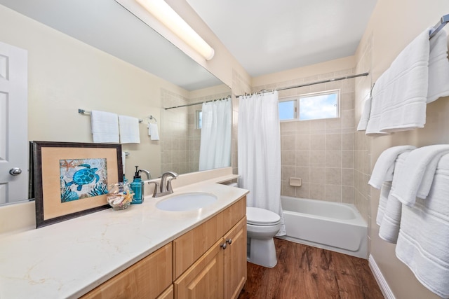 bathroom featuring toilet, vanity, shower / tub combo, and wood finished floors