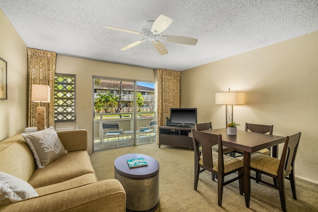 living room with carpet floors, ceiling fan, and a textured ceiling