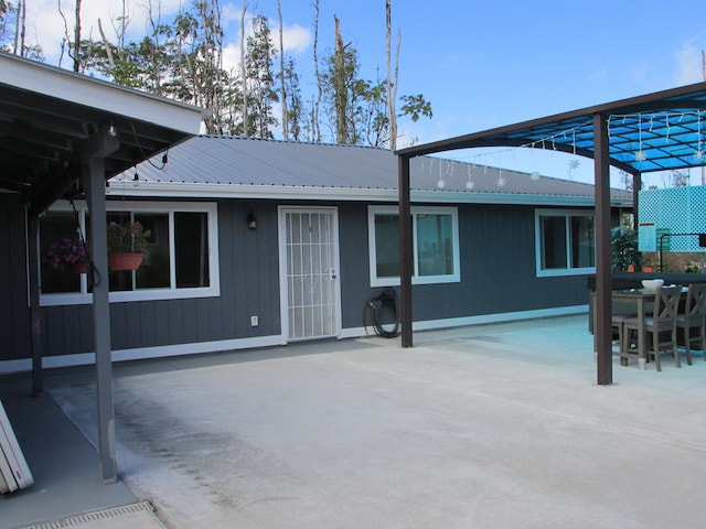 exterior space with metal roof and a patio area