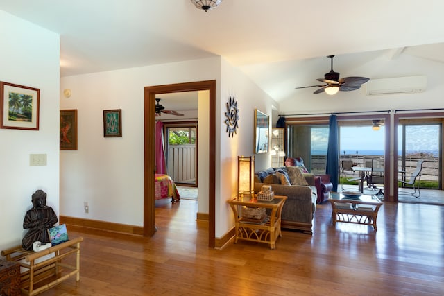 living room featuring vaulted ceiling with beams, a ceiling fan, wood finished floors, and an AC wall unit
