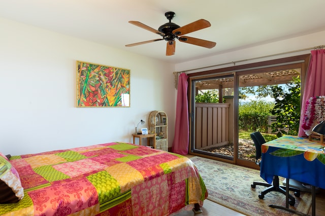 bedroom with a ceiling fan, wood finished floors, and access to outside