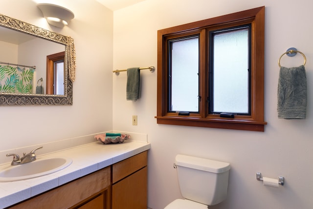 full bath featuring toilet and vanity