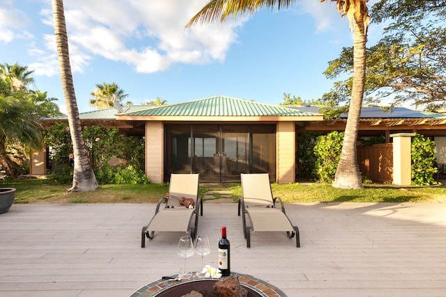 wooden deck featuring an outdoor fire pit and french doors