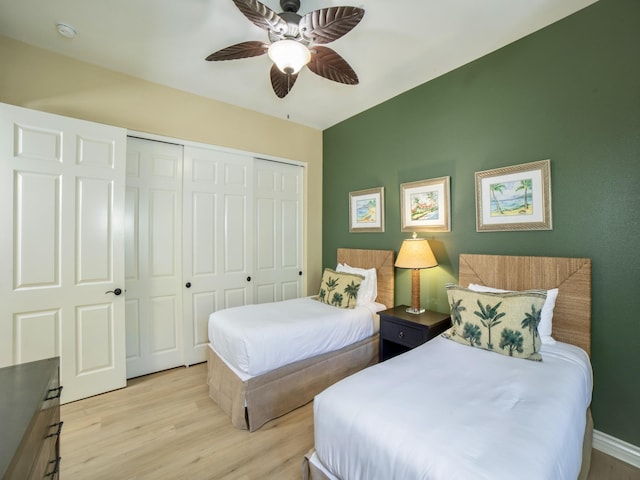 bedroom featuring light wood-type flooring, a closet, and ceiling fan