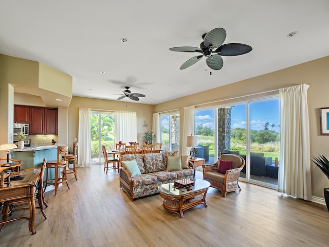 living room featuring recessed lighting, light wood-style flooring, and ceiling fan